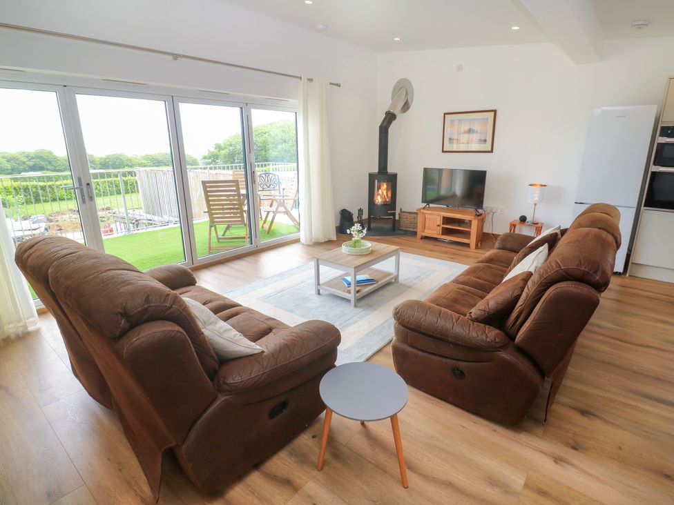A living room with a sofa and a coffee table at Swallows Nest in St. Ives