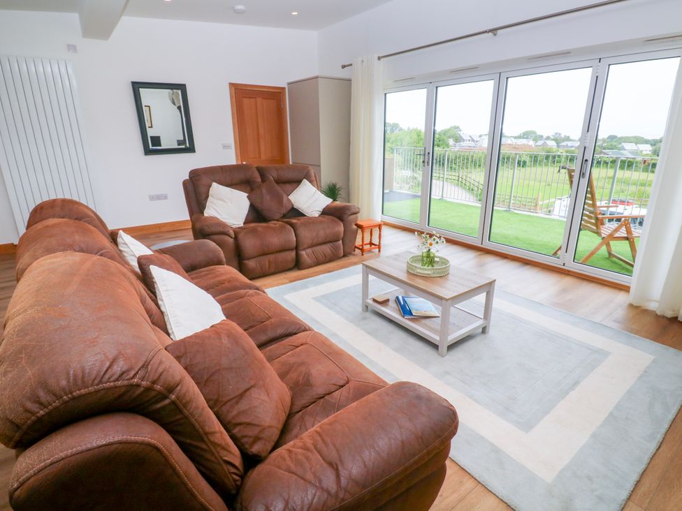 A living room with a sofa and coffee table at Swallows Nest in St. Ives