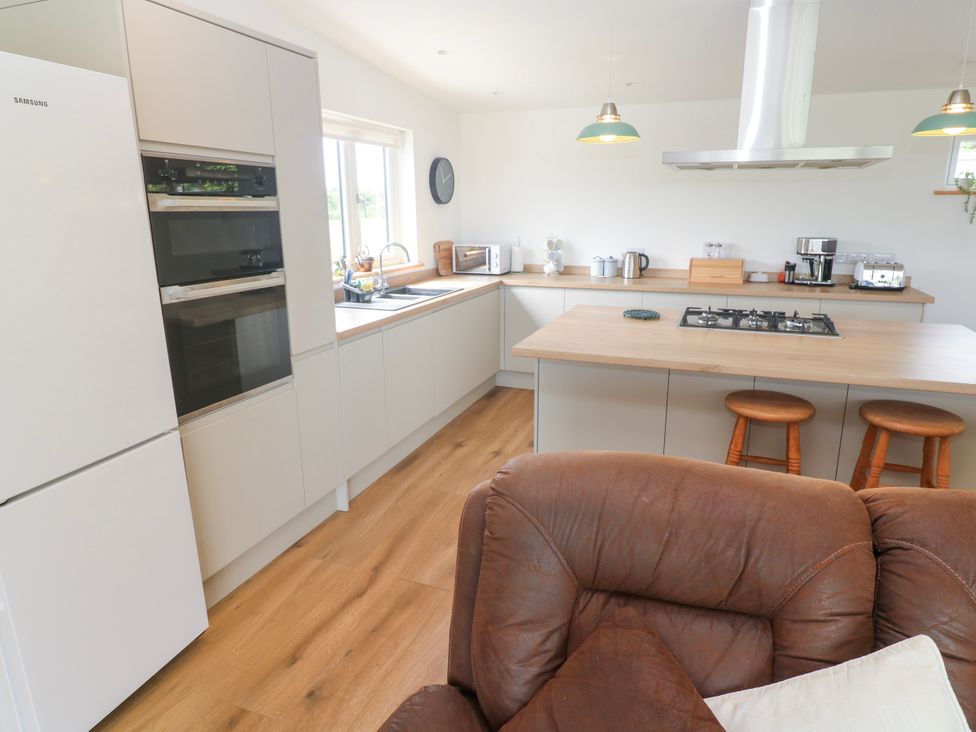 A kitchen with appliances and a countertop at Swallows Nest in St. Ives