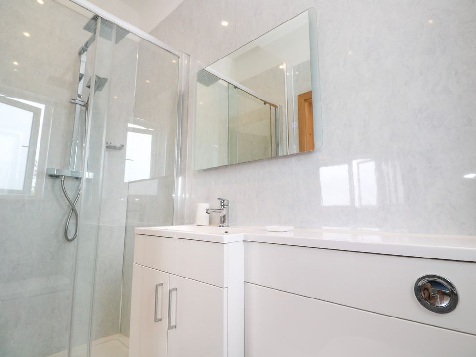 A bathroom with a shower and sink at Swallows Nest in St. Ives