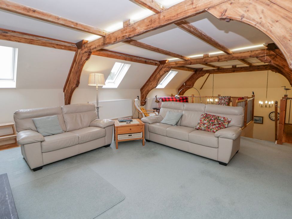 A living room with sofas and a table at Yr Hen Ysgoldy