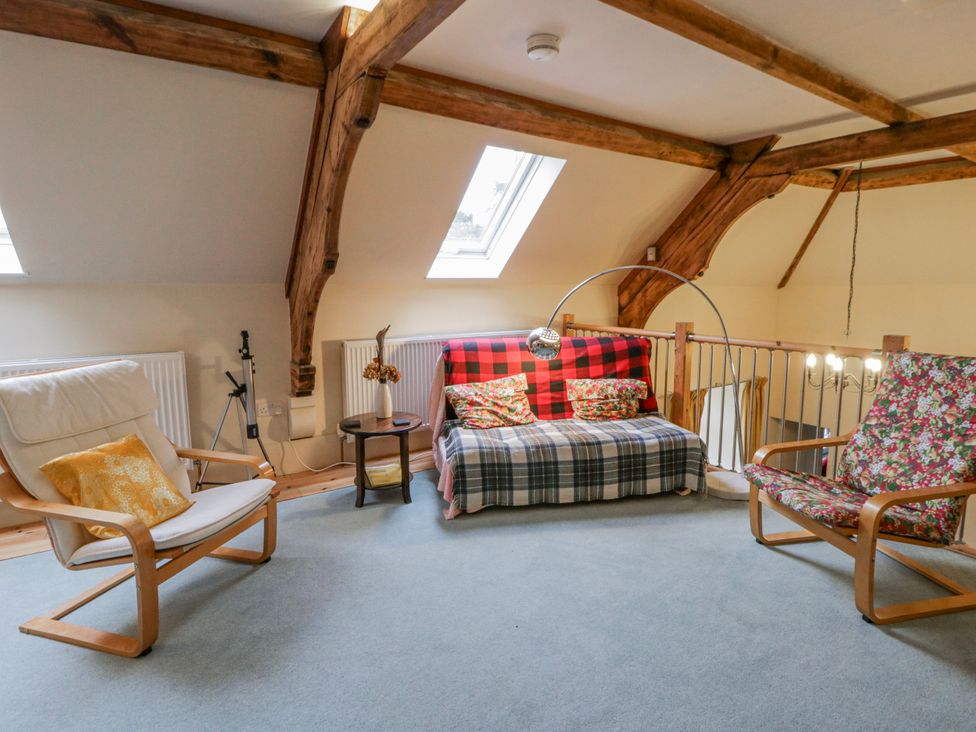 A living room with a sofa, armchairs and a coffee table at Yr Hen Ysgoldy