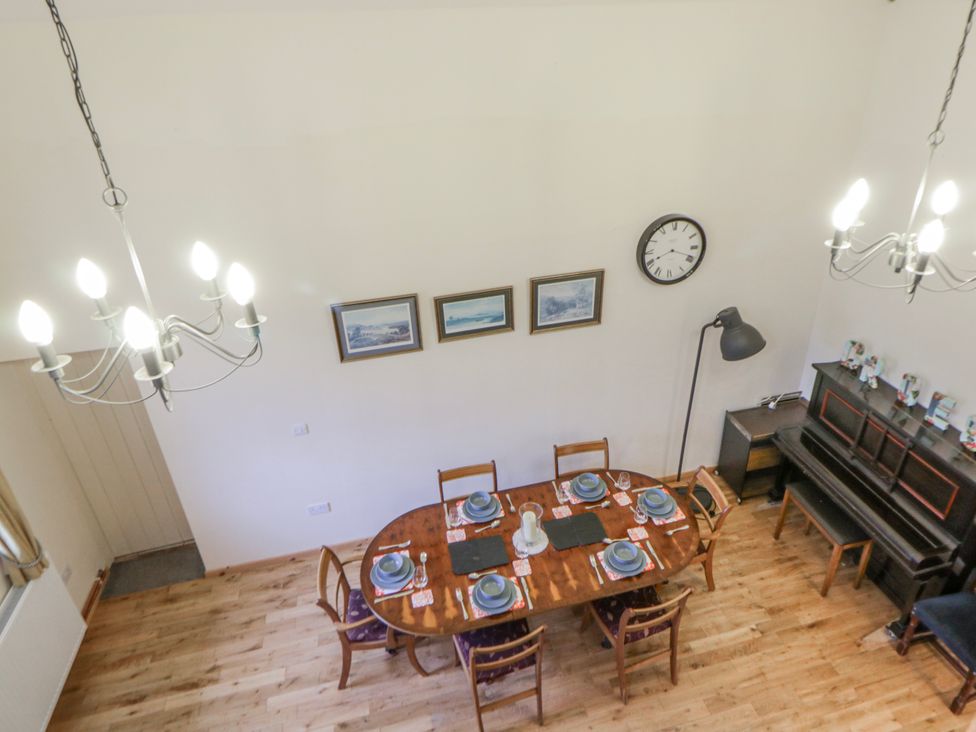 A dining room with a table set for dinner at Yr Hen Ysgoldy