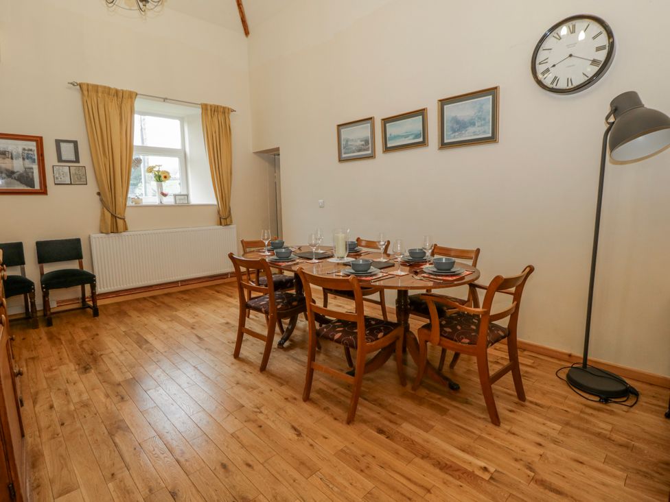 A dining room with a table set for meals at Yr Hen Ysgoldy