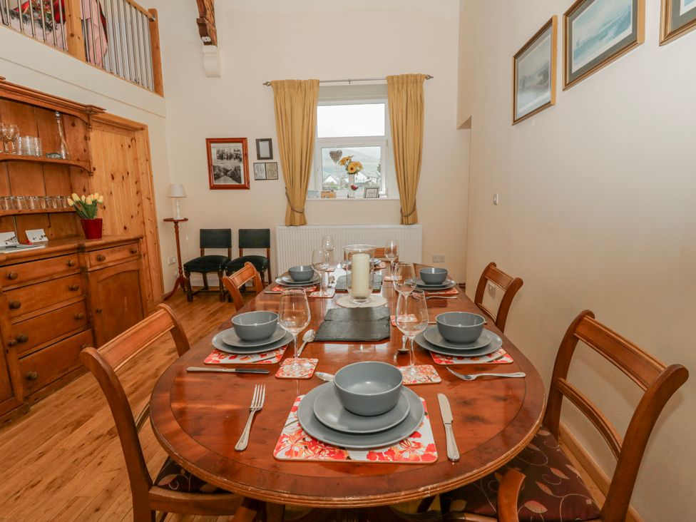A dining room with a table set for meals at Yr Hen Ysgoldy