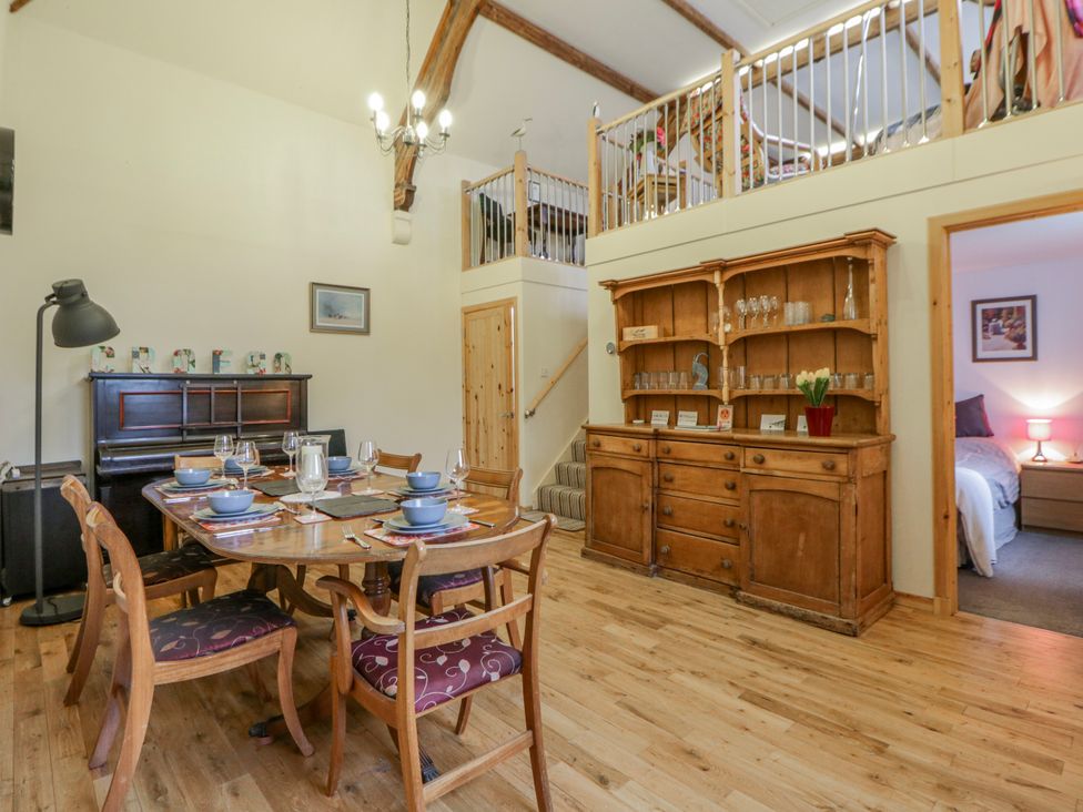 A dining room with a table set for meals at Yr Hen Ysgoldy 