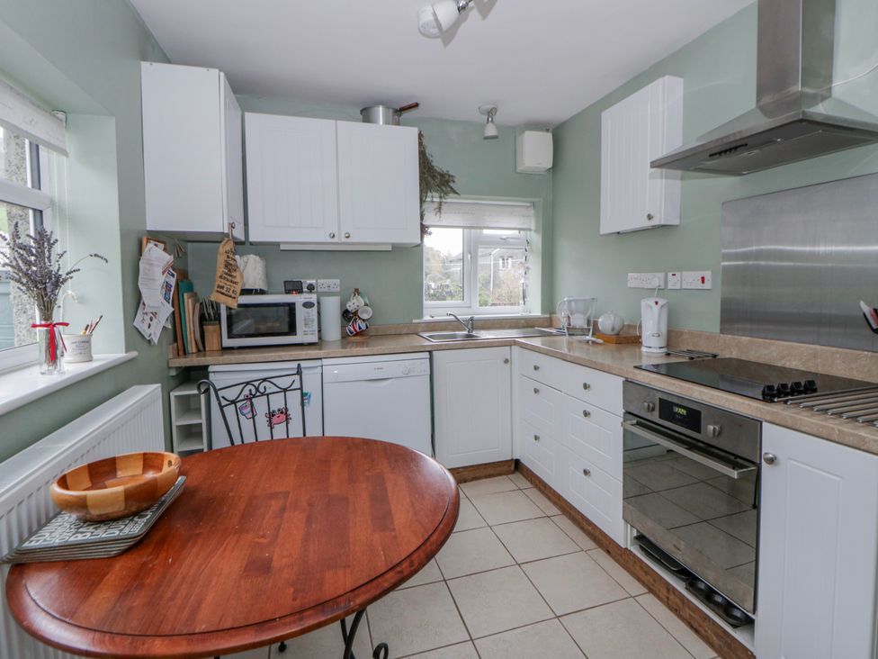 A kitchen with appliances and a table at Yr Hen Ysgoldy