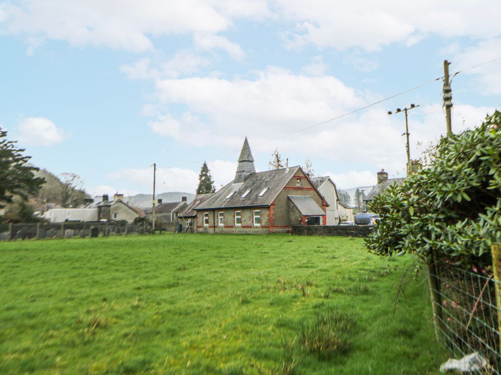 A house surrounded by grass and trees at Yr Hen Ysgoldy in 