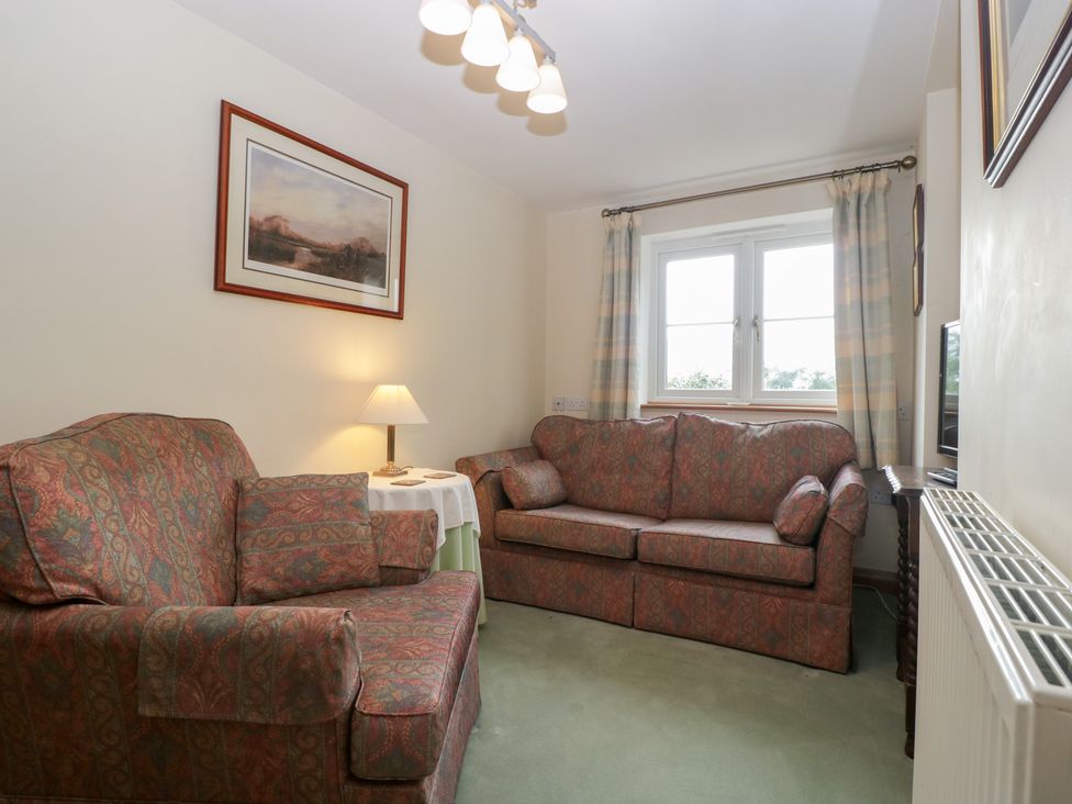 A living room with a sofa and armchair at Wren Cottage in Ross-on-Wye