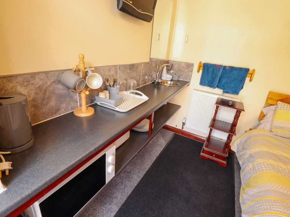 A kitchen area with a sink and microwave at Dakota in 