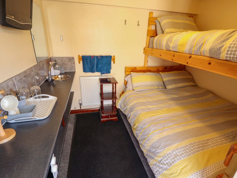 A bedroom with a bunk bed and a double bed at Dakota in 
