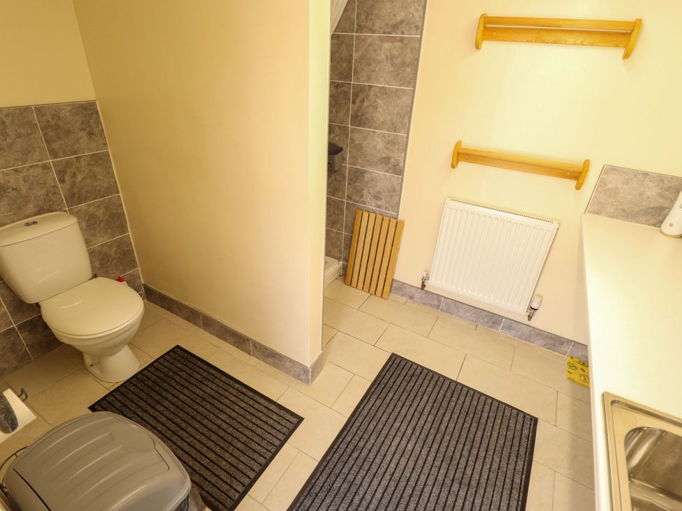 A bathroom with a toilet and a shower at Dakota