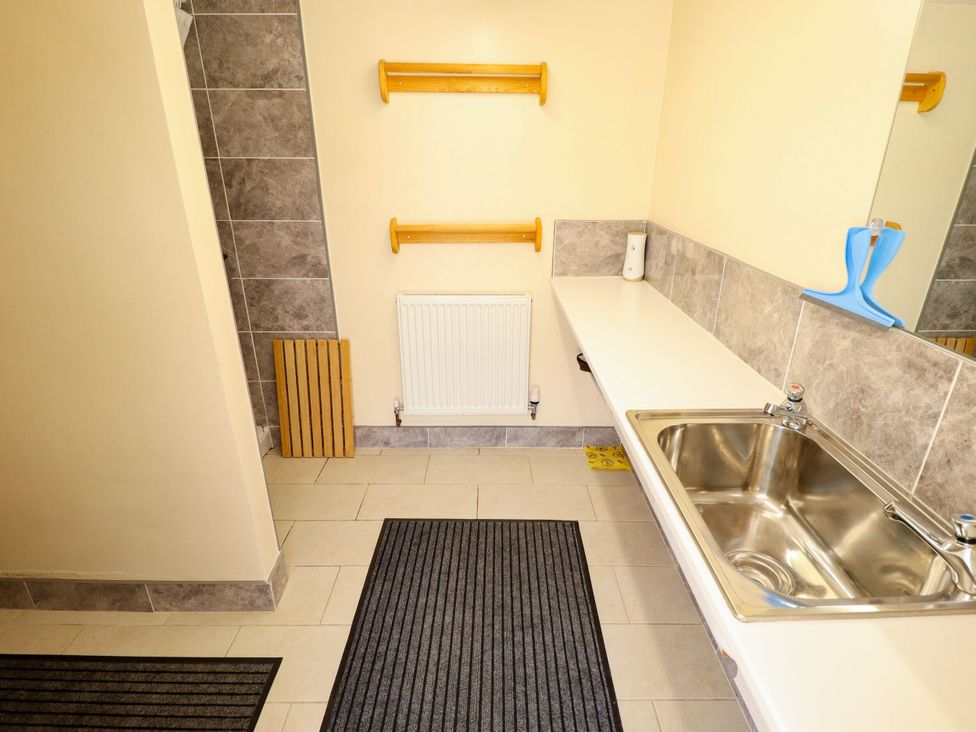 A bathroom with a sink and shelves at Dakota in New York near Coningsby