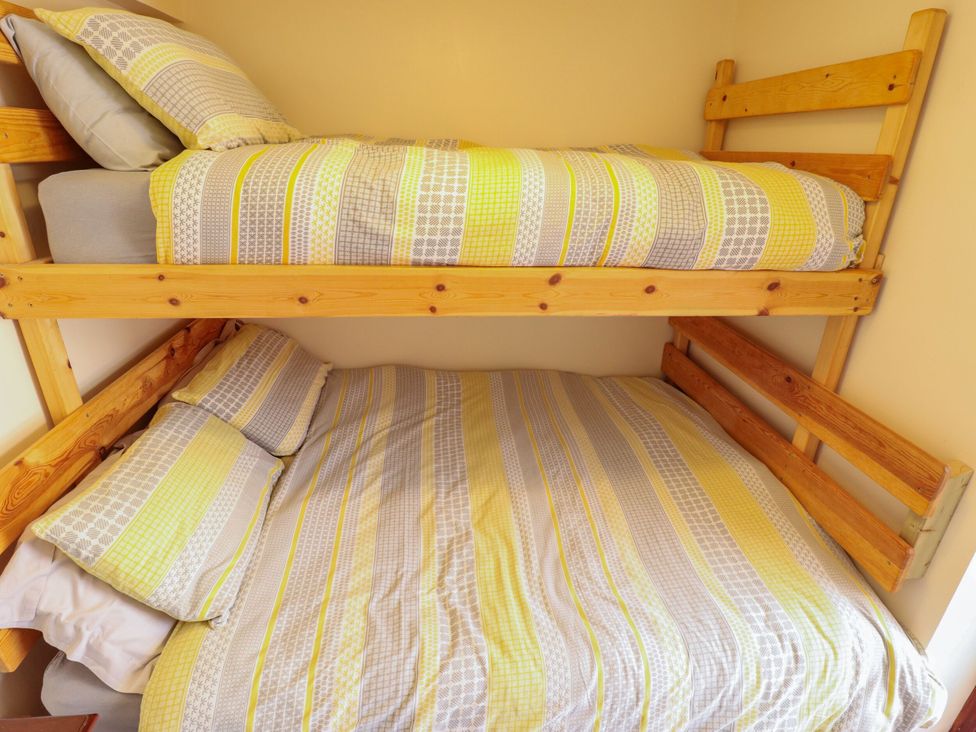 A bunk bed with striped bedding at Lancaster, New York near Coningsby