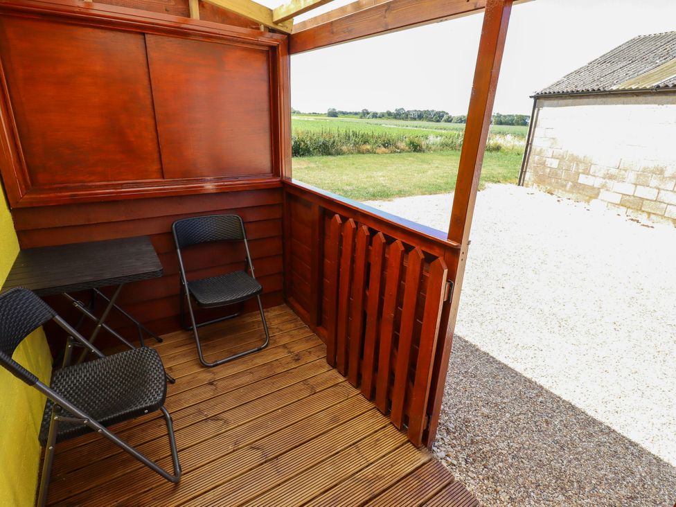 An outdoor area with two chairs and a small table at Lancaster near Coningsby
