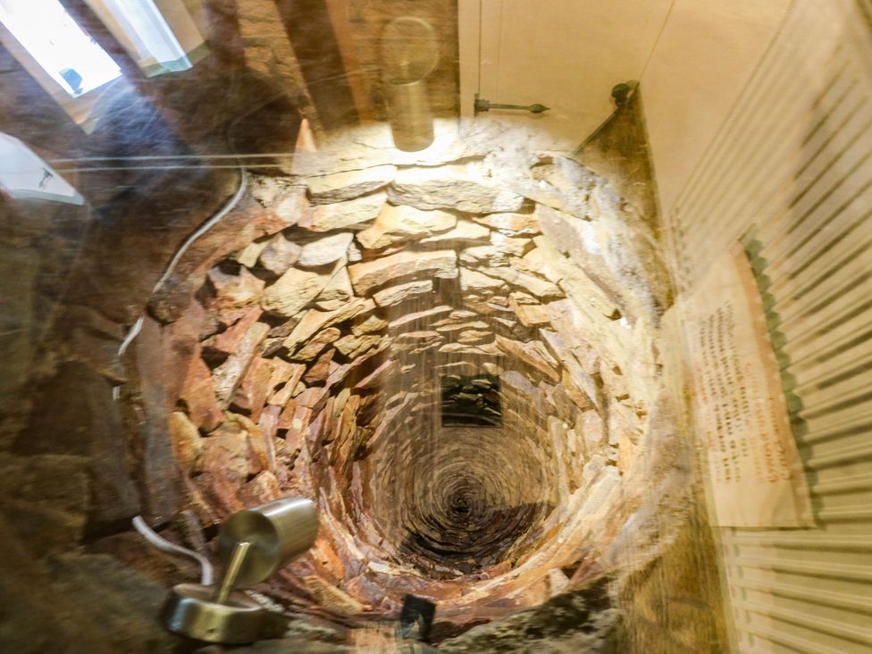 A stone well viewed from above at Winberry Cottage in Haworth