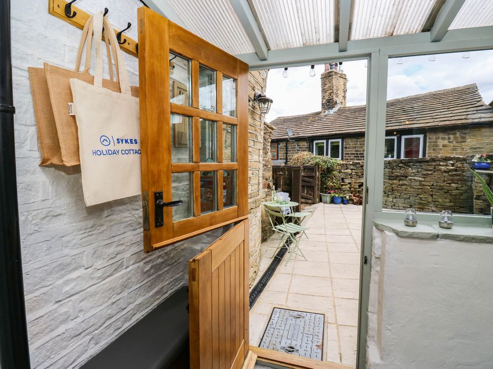 An entryway leading to a patio area at Winberry Cottage in Haworth