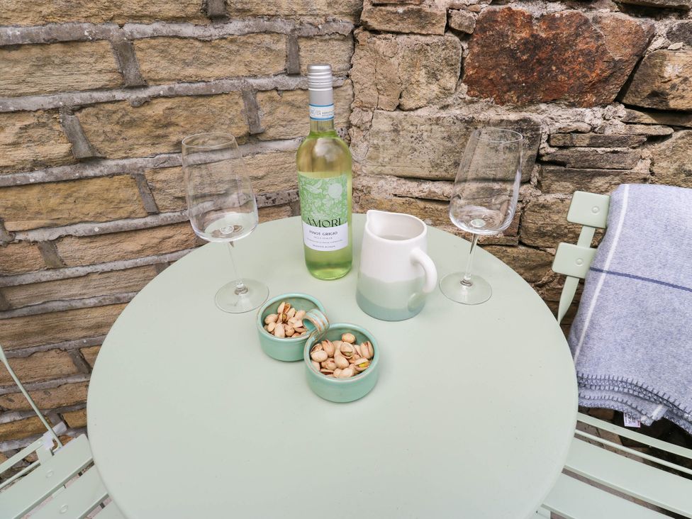 A table with wine and snacks at Winberry Cottage in Haworth