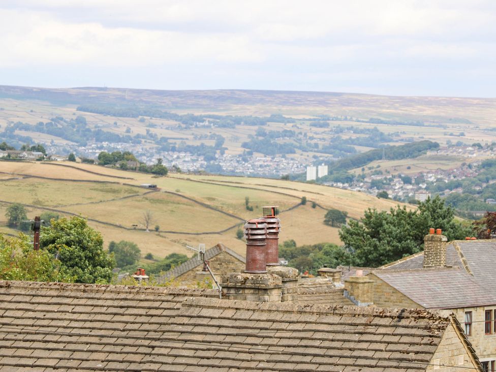 A view of hills and rooftops at Winberry Cottage in Haworth