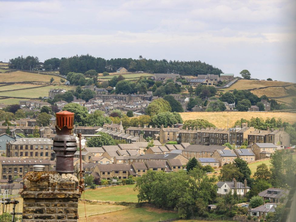 A view of buildings and hills at Winberry Cottage in Haworth