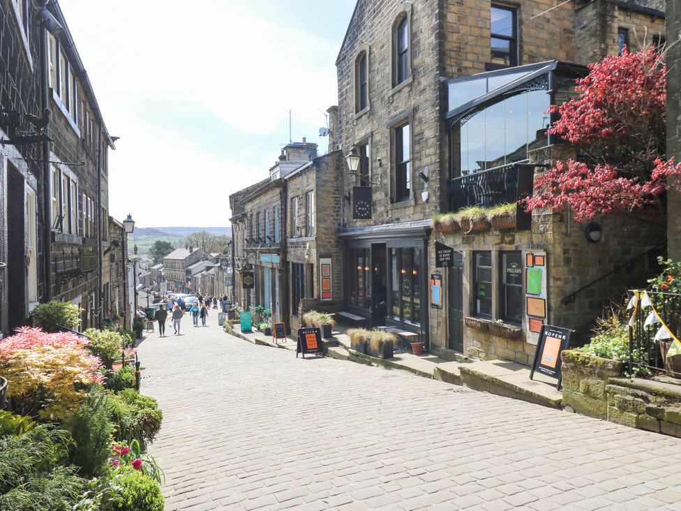 A street with buildings and people at Winberry Cottage in Haworth