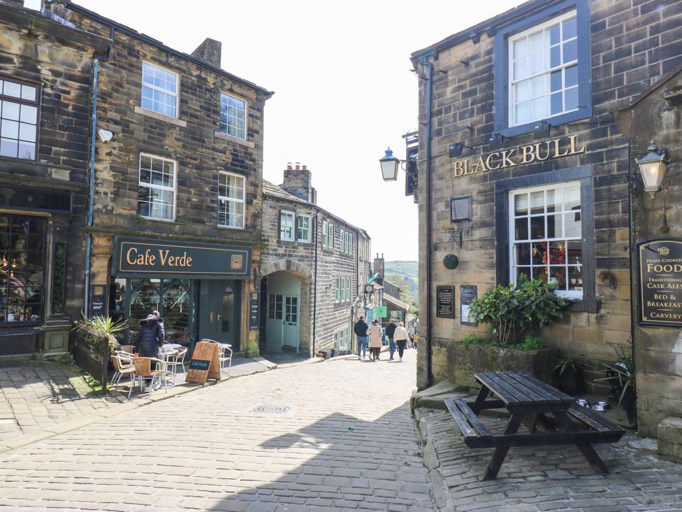 A street with Cafe Verde and Black Bull in Haworth