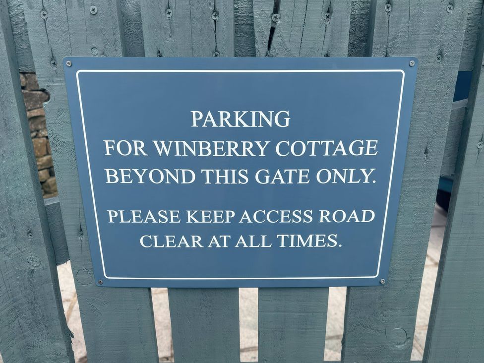 A parking sign for Winberry Cottage by the gate in Haworth