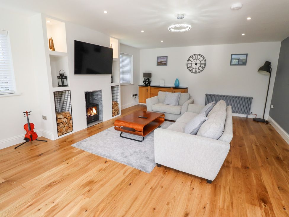 A living room with a television and a coffee table at Rose Cottage Dunstan near Embleton
