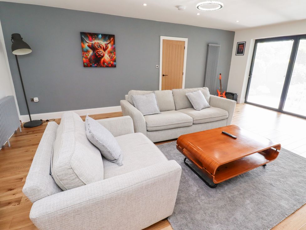A living room with sofas and a coffee table at Rose Cottage Dunstan near Embleton