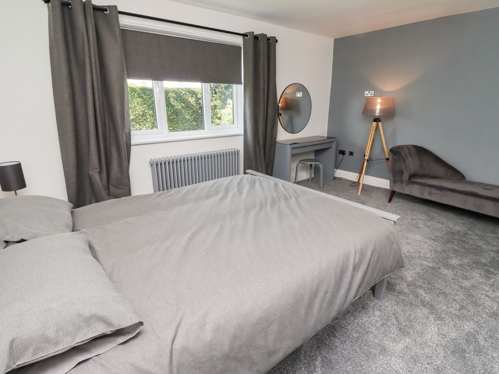 A bedroom with a bed and a desk at Rose Cottage in Dunstan near Embleton