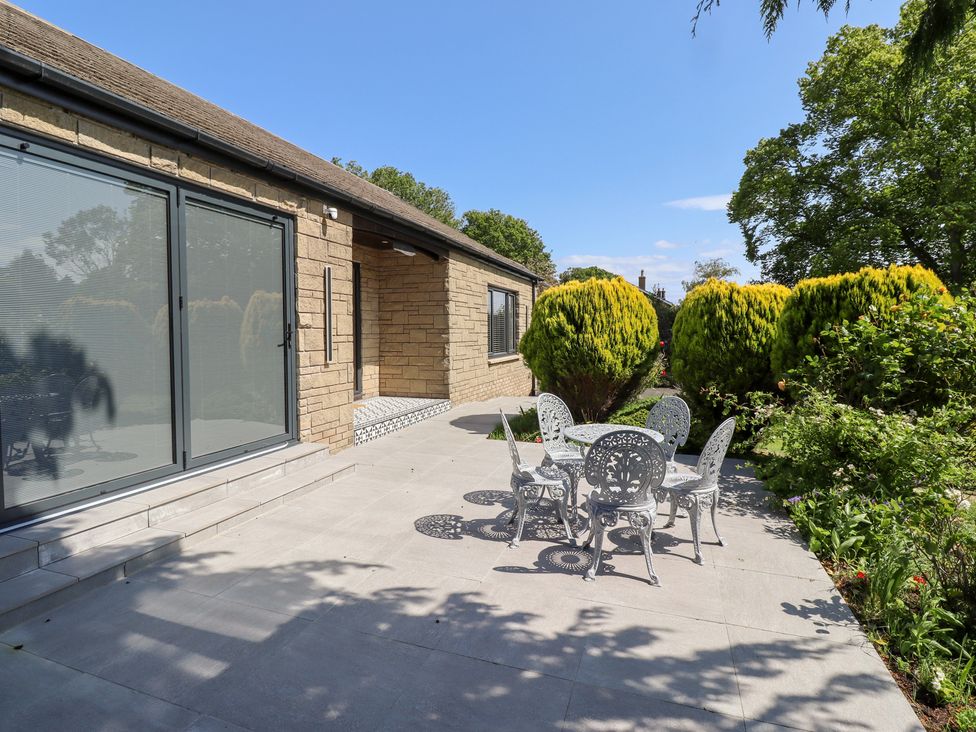A patio with a table and chairs at Rose Cottage in Dunstan near Embleton