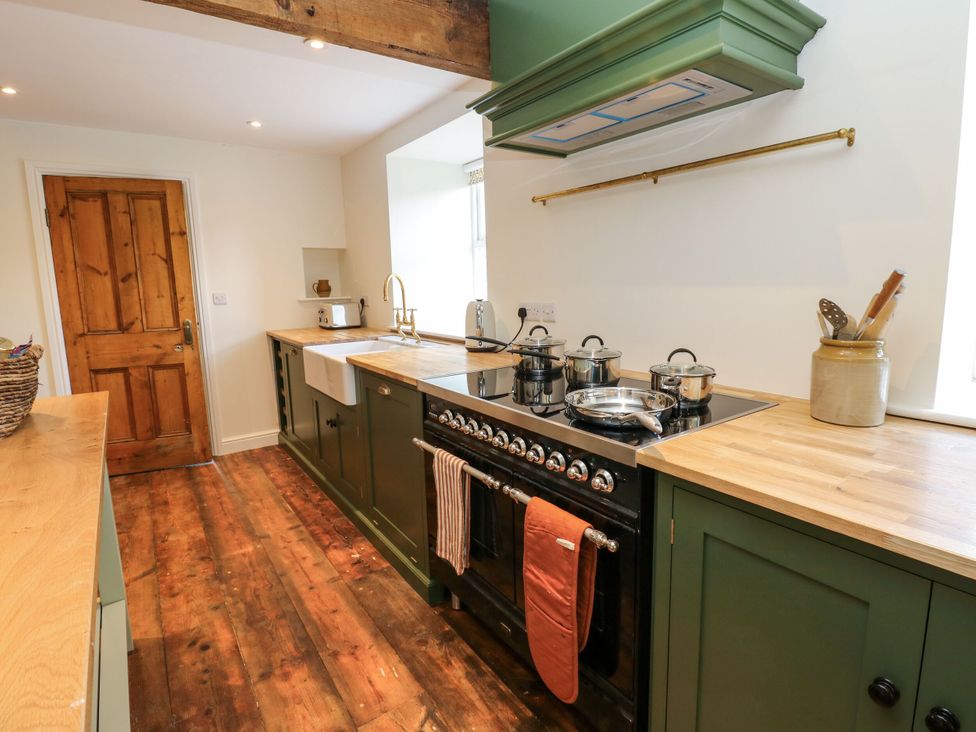 A kitchen with a stove and sink at High Meadow Barn Thornton Rust near Bainbridge