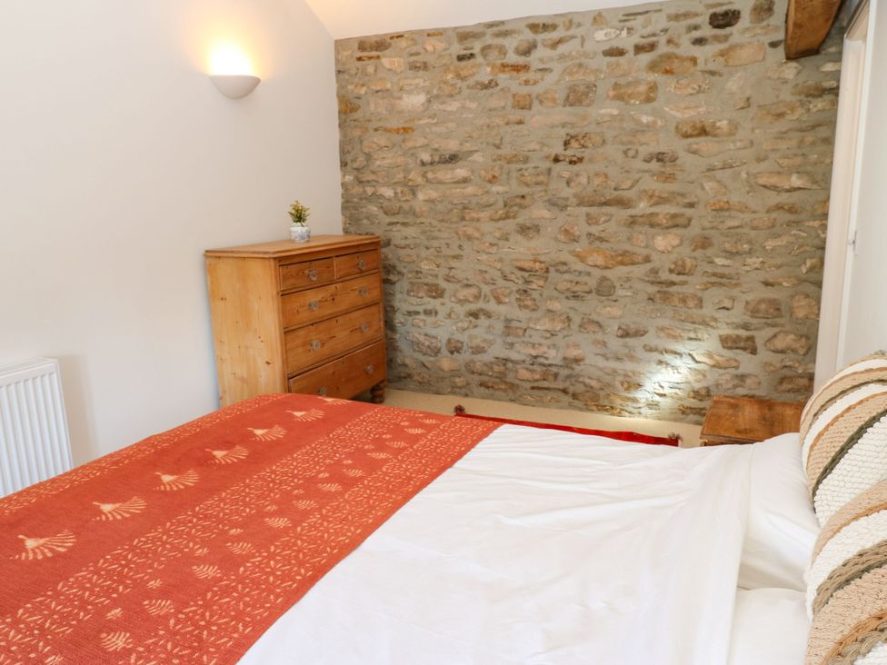 A bedroom with a bed and a dresser at High Meadow Barn Thornton Rust near Bainbridge