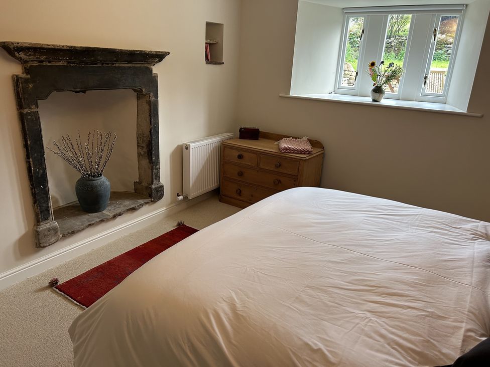 A bedroom with a bed and chest of drawers at High Meadow Barn Thornton Rust near Bainbridge