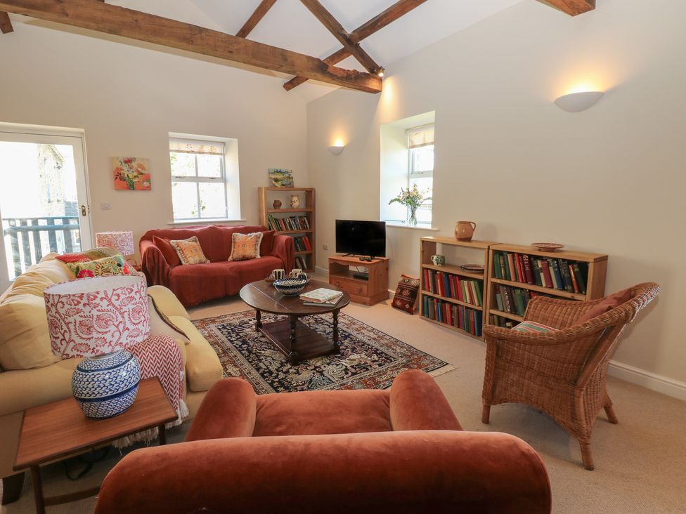 A living room with a sofa and a coffee table at High Meadow Barn Thornton Rust near Bainbridge