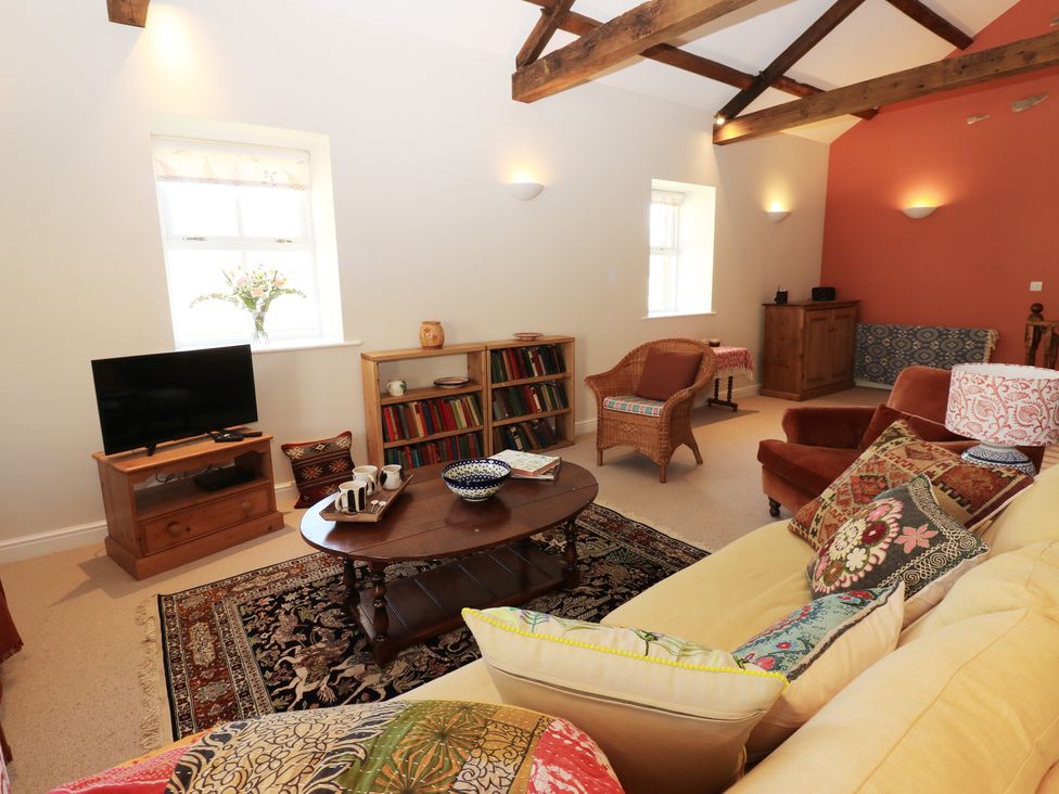 A living room with a sofa and coffee table at High Meadow Barn Thornton Rust near Bainbridge