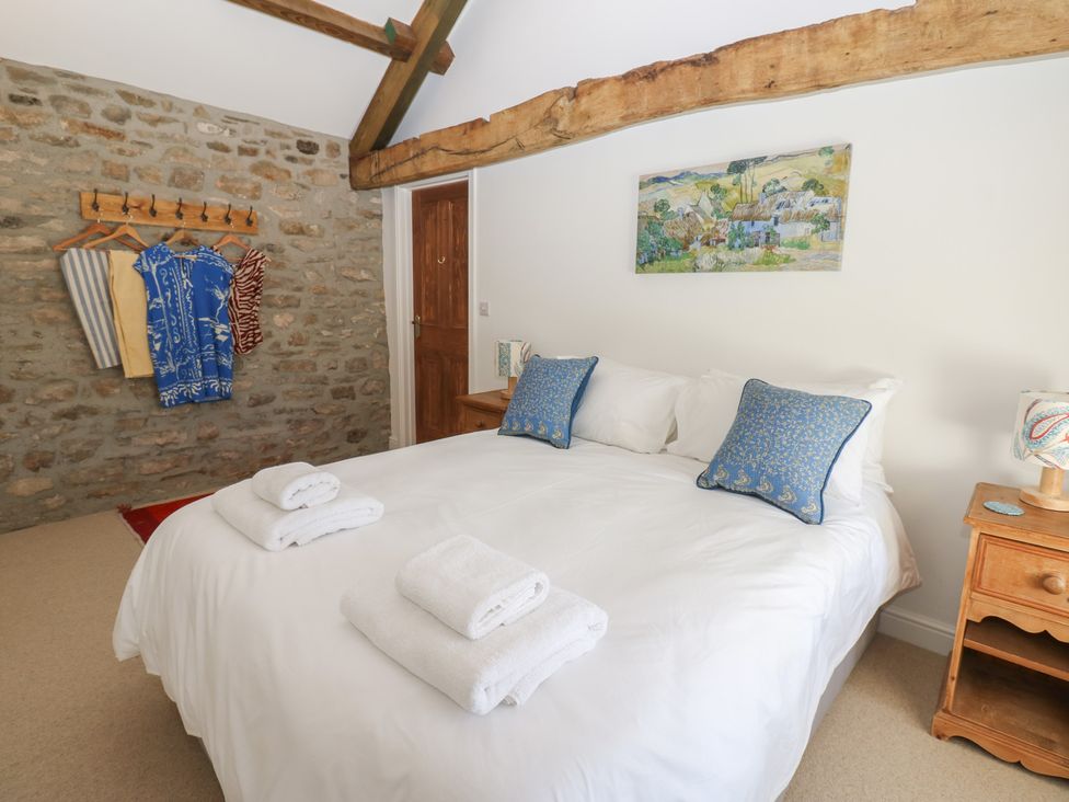A bedroom with a large bed and decorative items at High Meadow Barn Thornton Rust near Bainbridge