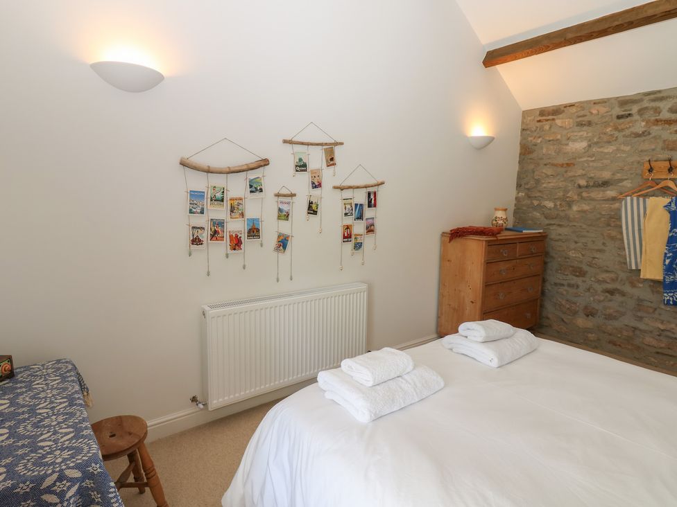 A bedroom with a bed and wall decorations at High Meadow Barn Thornton Rust near Bainbridge
