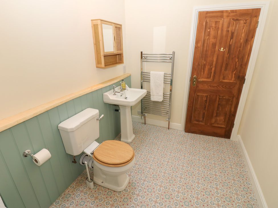 A bathroom with a sink and a toilet at High Meadow Barn in Thornton Rust near Bainbridge