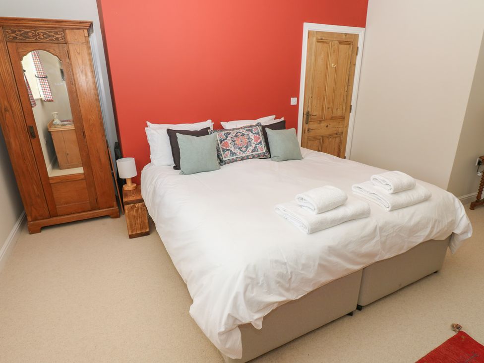 A bedroom with a bed and a dresser at High Meadow Barn Thornton Rust near Bainbridge