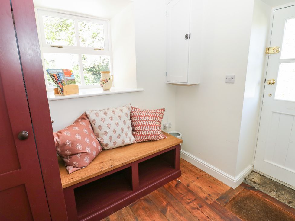 An entryway with a bench and cushions at High Meadow Barn Thornton Rust near Bainbridge