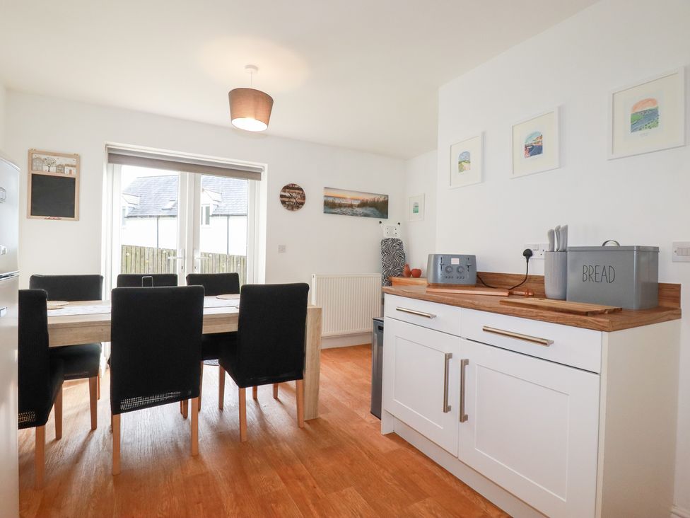 A dining room with a table and chairs at Poldam in St Austell