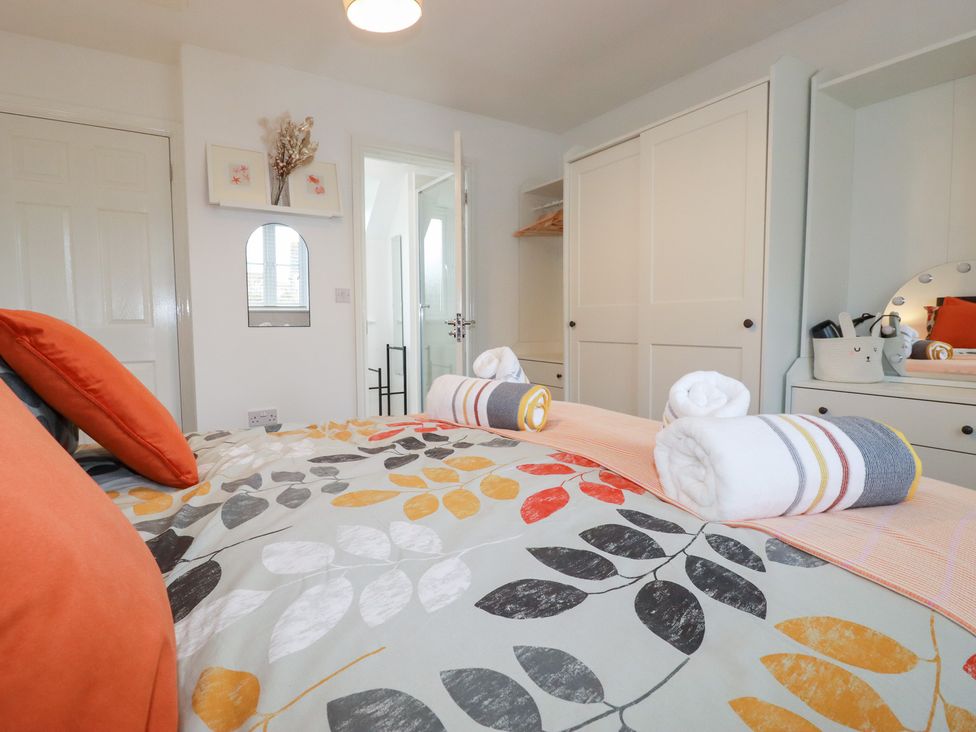 A bedroom with a bed and wardrobe at Poldam St Austell