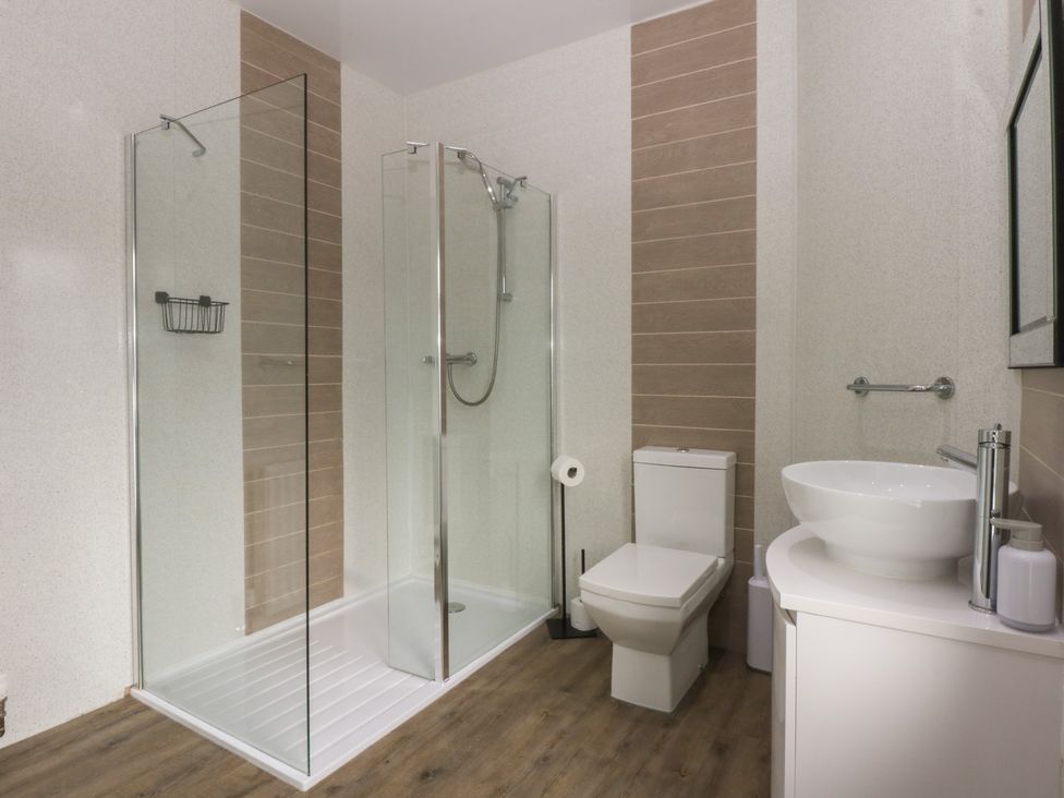 A bathroom with shower, toilet and sink at Ty Llwyd in Llandudno