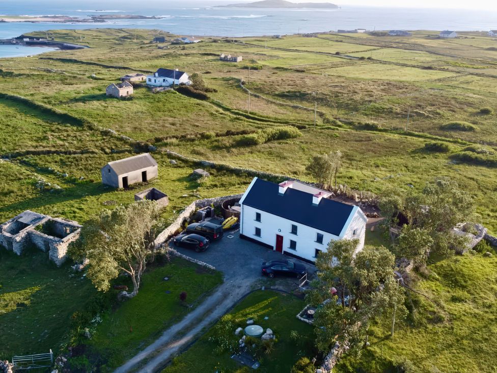 An aerial view of a house and shed in a rural landscape at Nead na bhFáinleog (Swallows’ Nest), Claddaghduff, County Galway