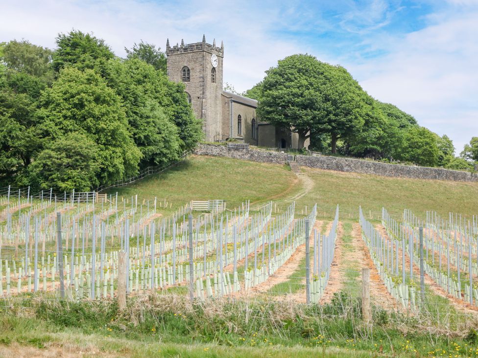 A church on a hill surrounded by vineyards at The Stables in Stockport