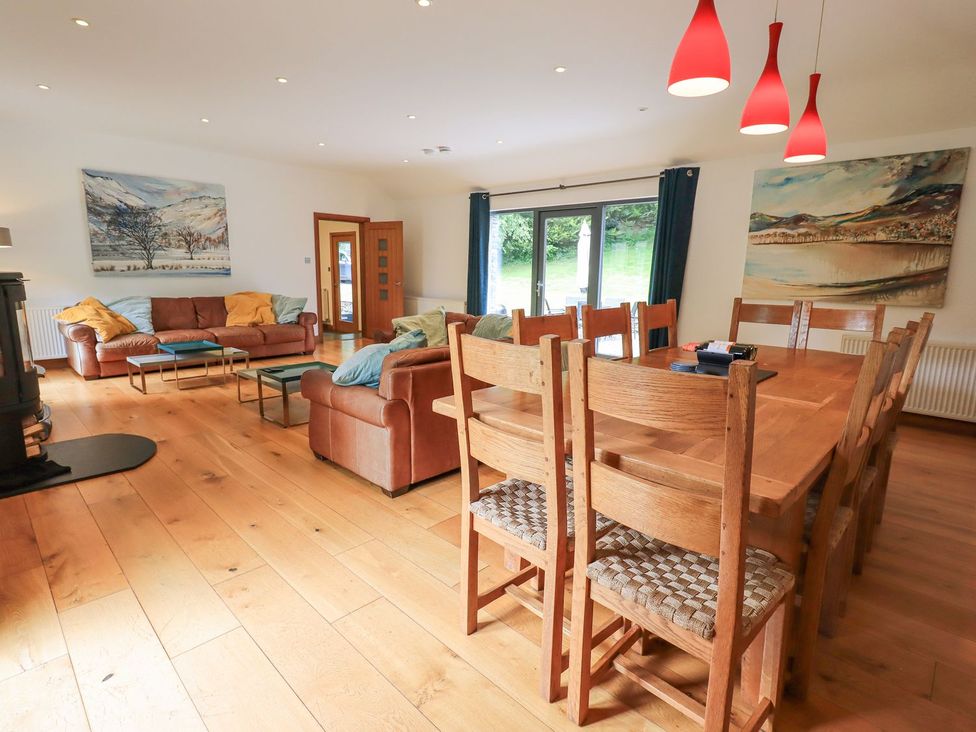 A living room with a sofa and dining area at Bracken Ground in Coniston
