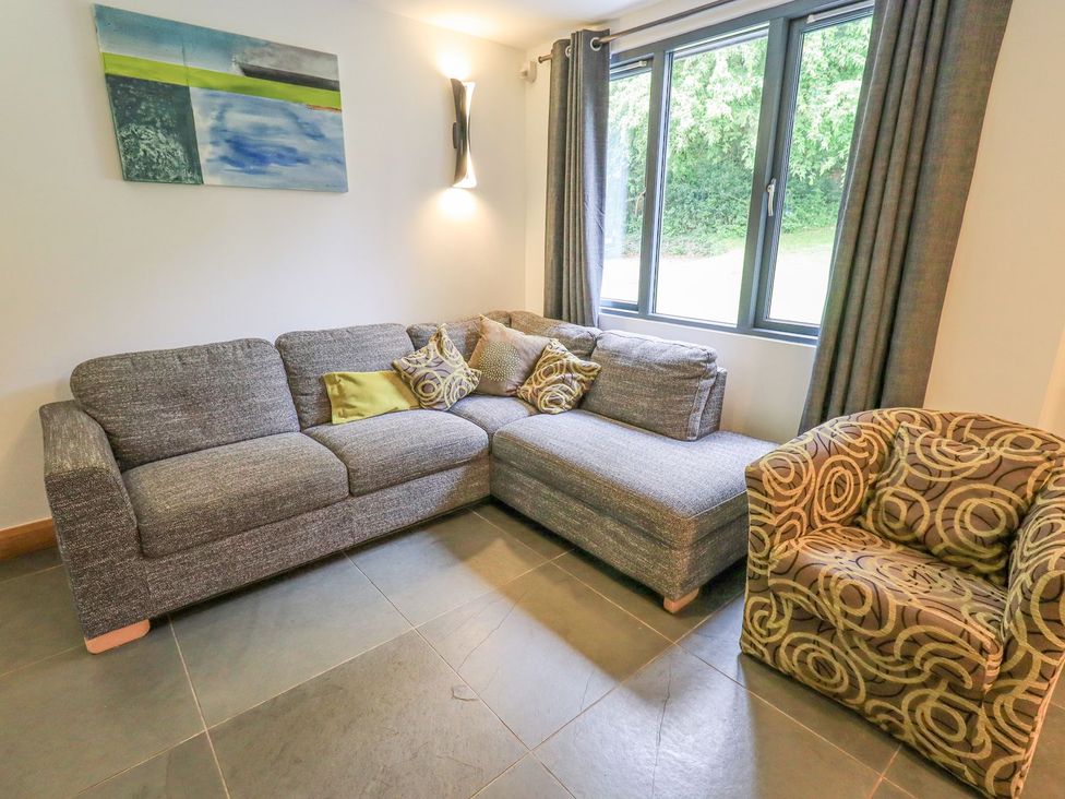 A living room with a sofa and armchair at Bracken Ground in Coniston