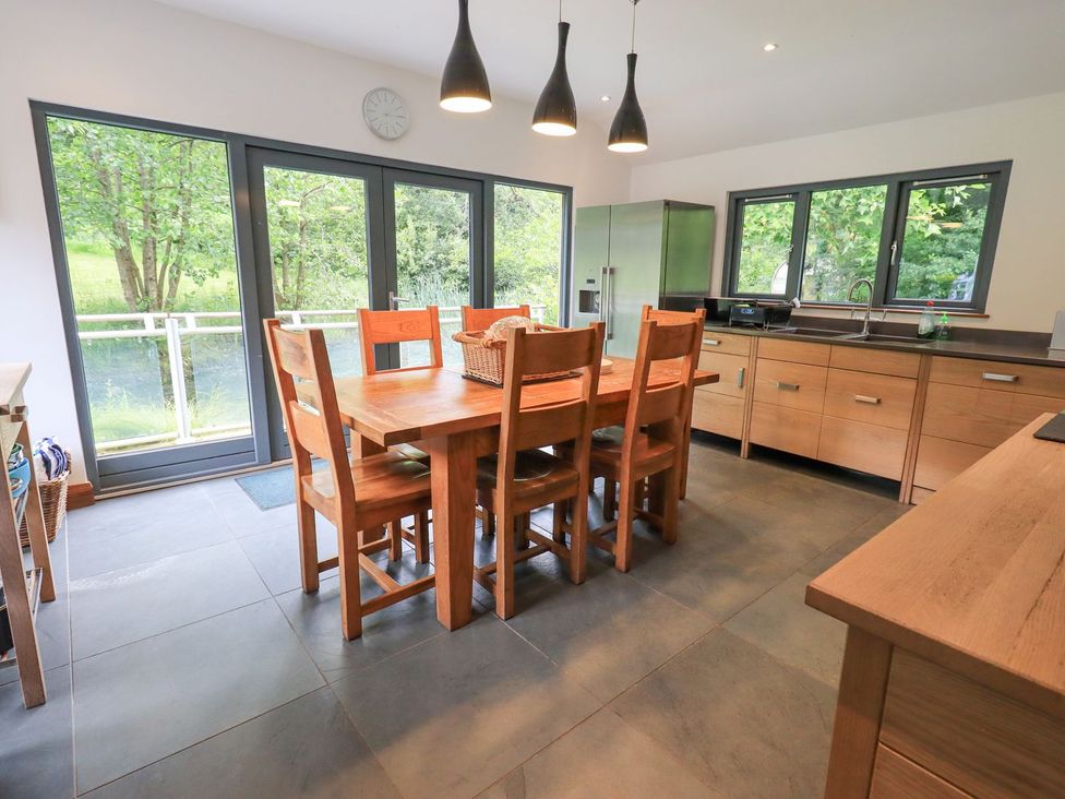 A kitchen with a table and chairs at Bracken Ground in Coniston