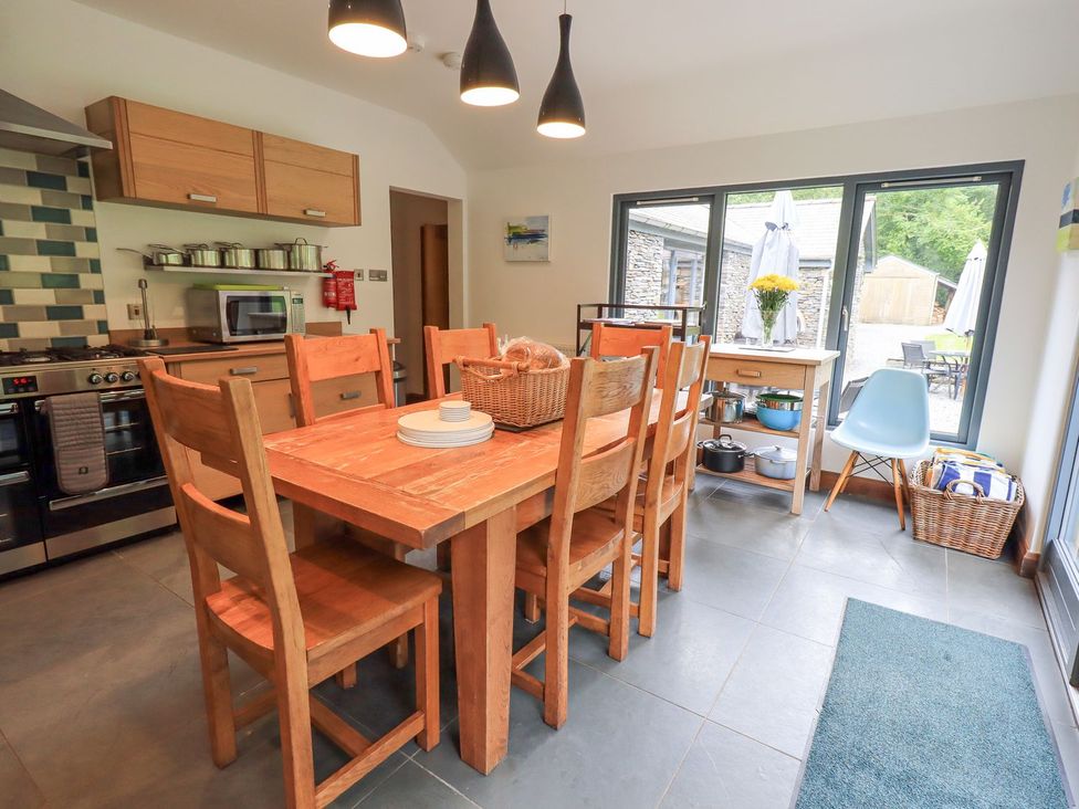 A kitchen with a dining table and chairs at Bracken Ground in Coniston